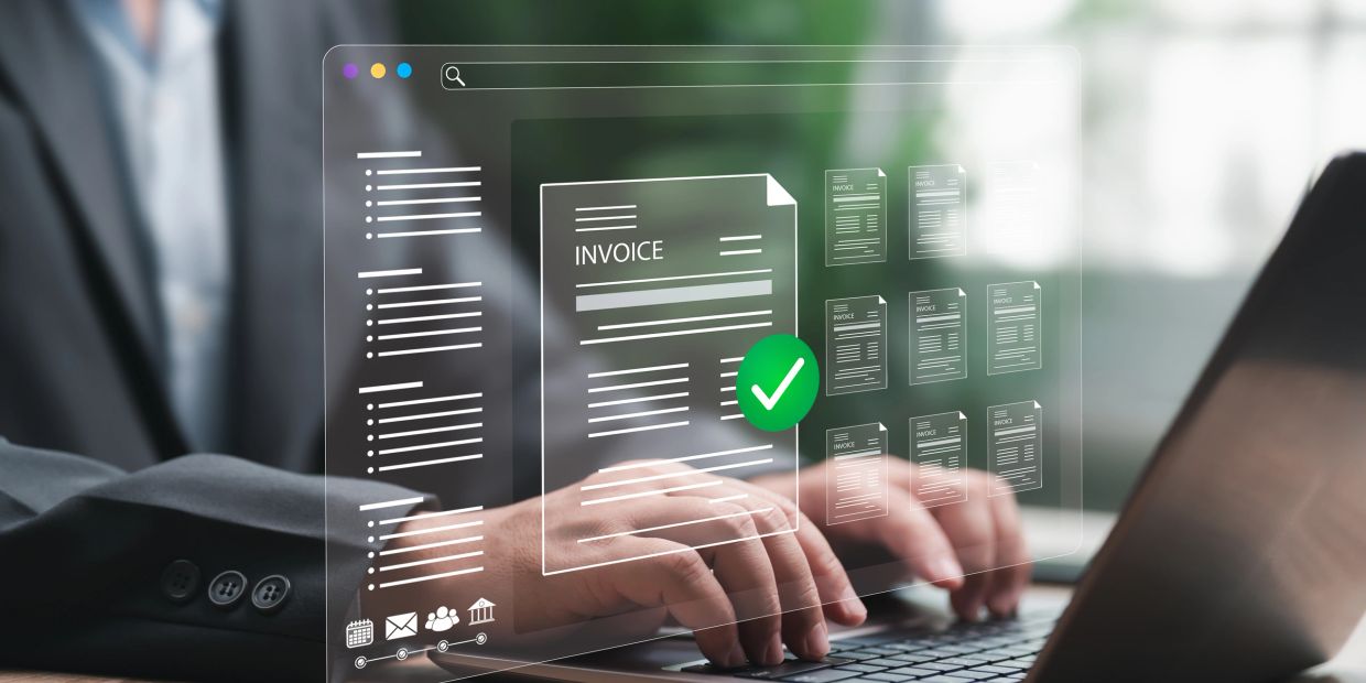 Person managing digital invoices on a transparent interface.
