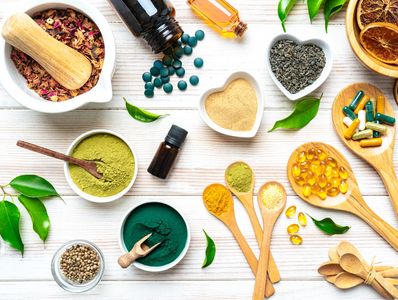 Various natural supplements and powders on a white wooden surface.