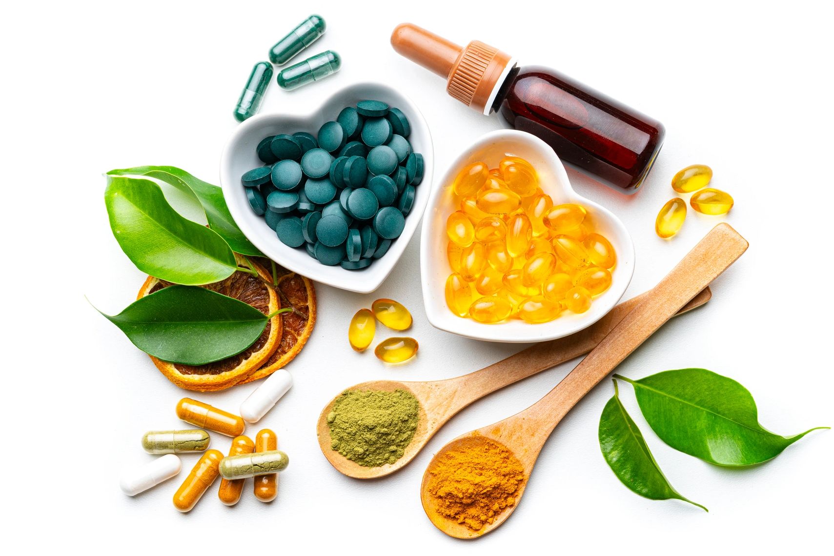 Various supplements and natural ingredients with green leaves.