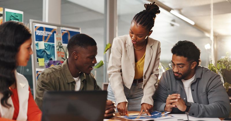 Creative people, meeting and documents in office for graphic design, planning and research. Digital agency, communication and worker with tech, social media or idea for website or ui project homepage