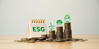 Stacks of coins with ESG and green energy icons symbolizing sustainable investments.
