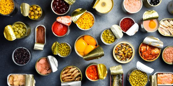 Variety of opened canned foods arranged on a table.