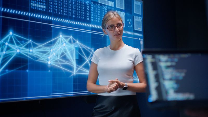 AI developers discussing and brainstorming during a collaborative meeting in a high-tech office. The scene highlights teamwork, data visualization on digital screens, and innovation in artificial intelligence development, reflecting a modern environment focused on building cutting-edge AI solutions.