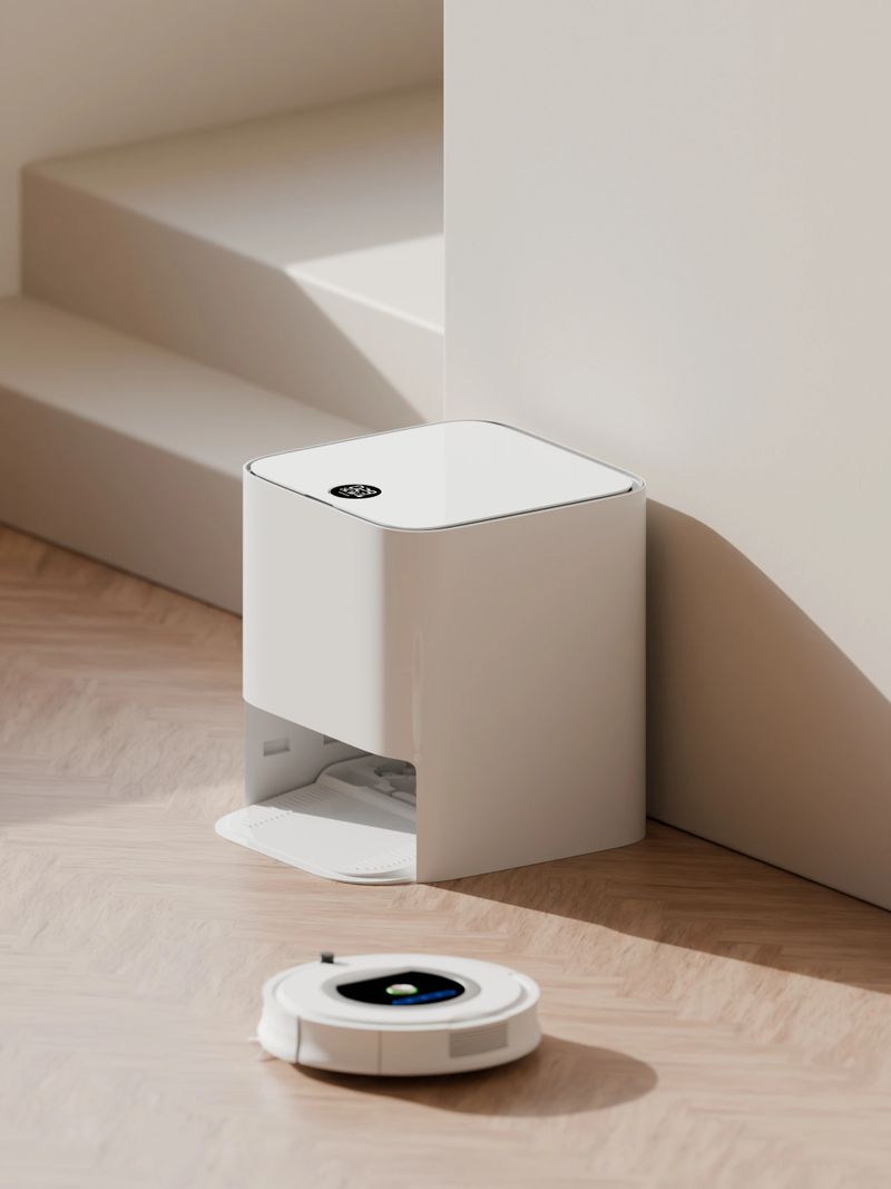 Modern minimalist living room interior featuring a cozy white sofa, smart robot vacuum cleaner, and natural sunlight. Stylish Scandinavian design with neutral colors, clean lines, and contemporary home technology for a sleek and elegant atmosphere.