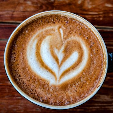 Latte art in the shape of a heart on a cappuccino.