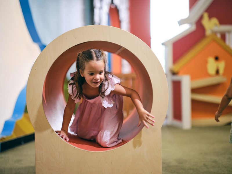 Children playing in an indoor playground in a children’s museum.