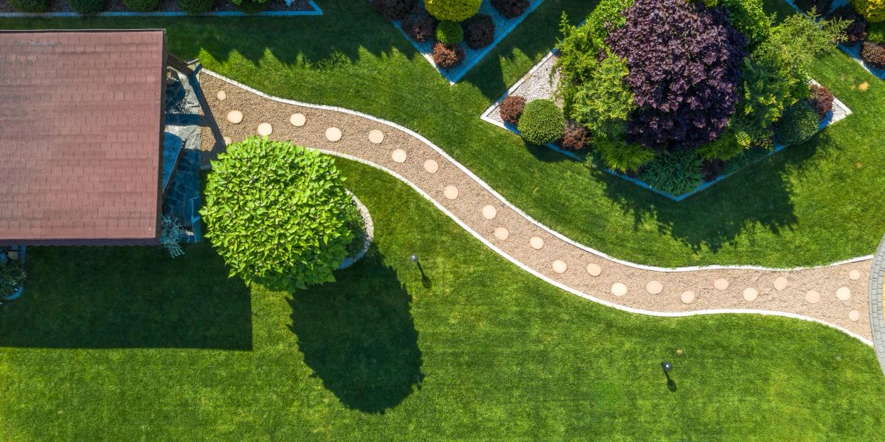 Aerial view of a garden with a curved pathway and trimmed bushes.