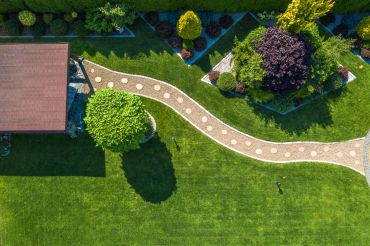 Aerial view of a landscaped garden with a pathway and green plants.