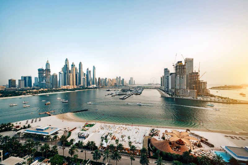Dubai Marina skyline featuring modern architecture, serene waterfront, and morning light conveying luxury, modernity, and travel appeal in a global cityscape.