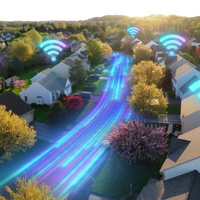A suburban neighborhood with digital Wi-Fi symbols and streaming blue light trails on the street.