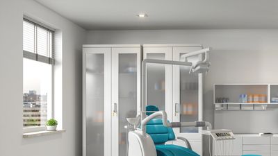 Modern dental clinic room with a blue dental chair.