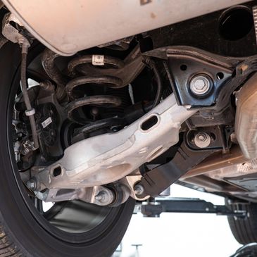 Undercarriage of a car showing suspension components.