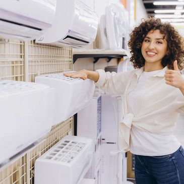 Smiling woman giving thumbs up while shopping for air conditioners.