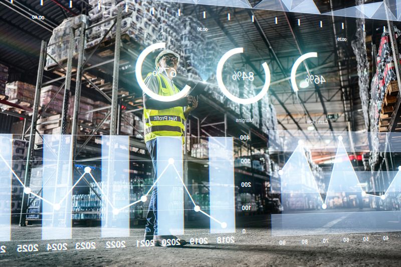 Employee analyzing virtual data with augmented reality interface in a warehouse