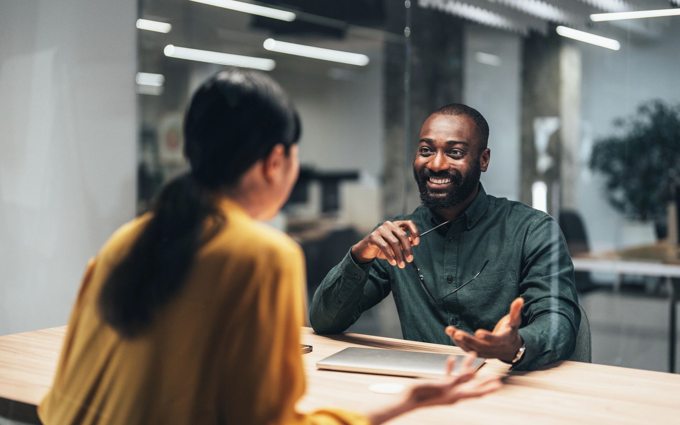 Two colleagues engaged in a friendly conversation at work.