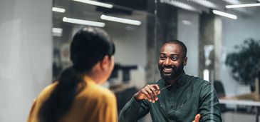Man reading a document thoughtfully at his desk.
