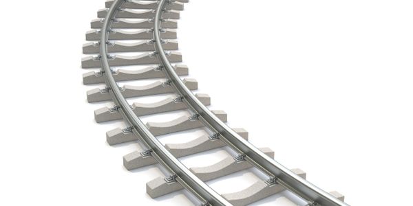 Curved section of railway track on a white background.