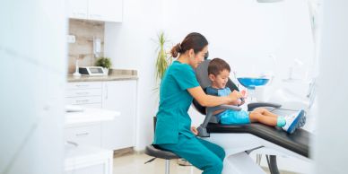 Dentist examining a young boy's teeth.