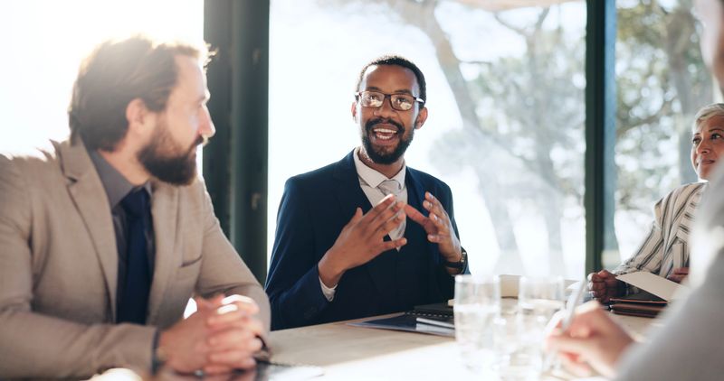 Businessman, talk and explain at meeting in boardroom, review and legal support at company. Person, lawyer and advocate for feedback, consultation and advice for compliance at corporate law firm
