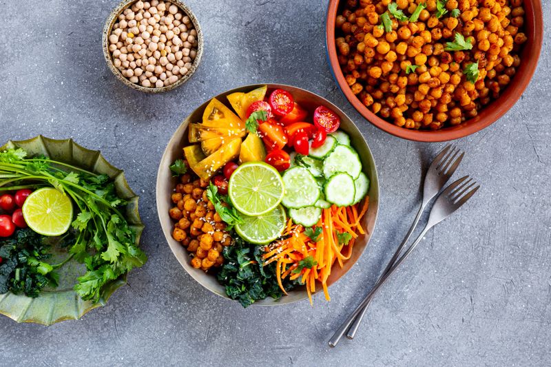 Buddha bowl - vegetarian bowl with chickpeas and fresh vegetables on the grey background top view. High quality photo