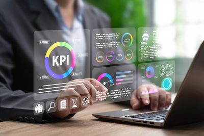 Businessman analyzing KPIs on a futuristic digital interface.