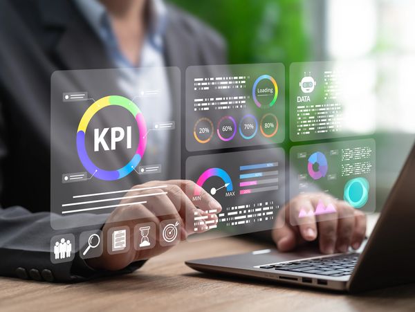 Businessman analyzing KPI data on a futuristic virtual interface.