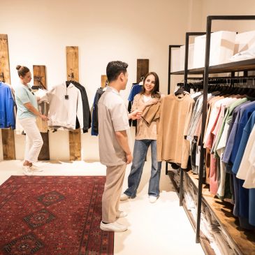 People shopping for clothes in a boutique store.
