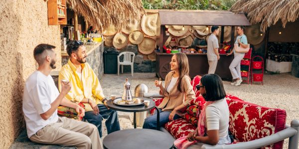 Friends enjoying drinks in a cozy outdoor setting.