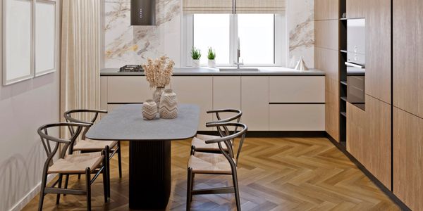 Modern kitchen with wood accents and a minimal dining table.