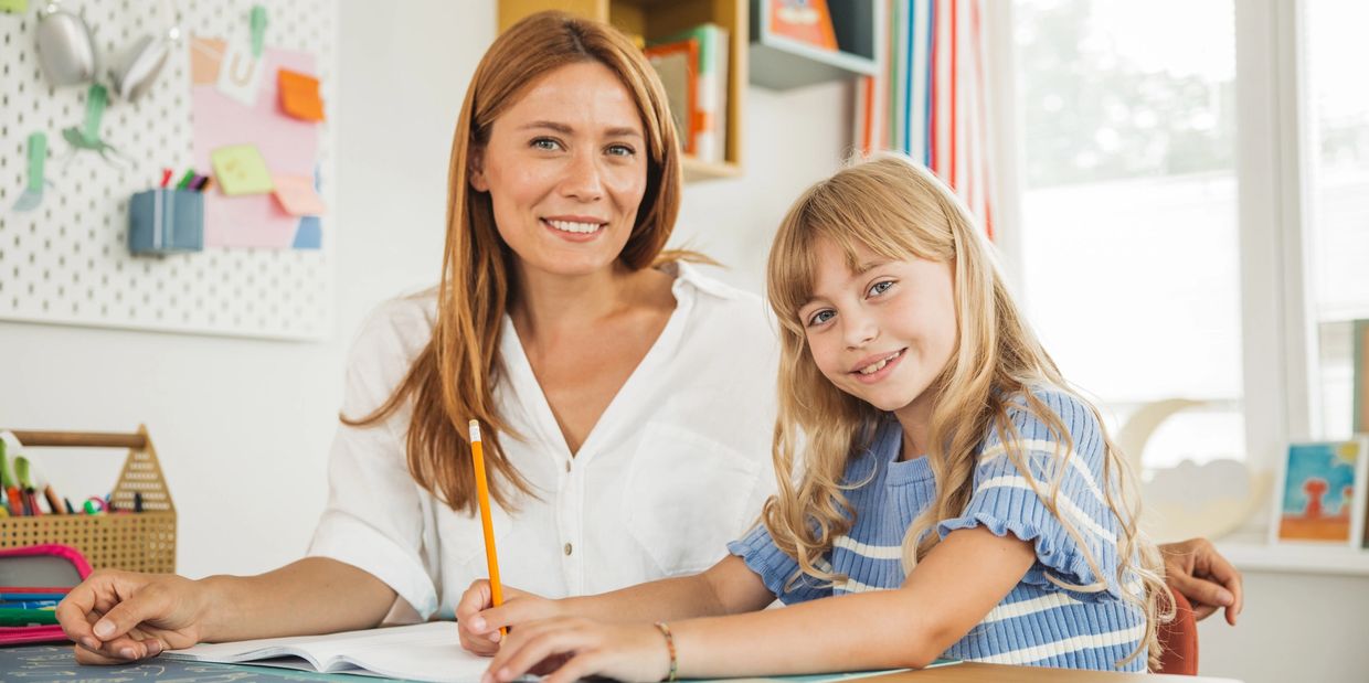 A woman and child Sit on the chair and look on the camera