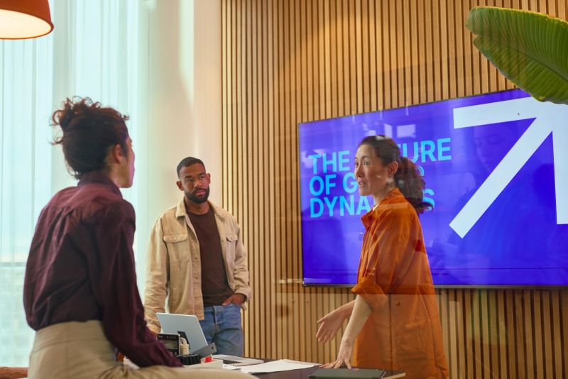 Diverse team of professionals engaging in a discussion about the future of group dynamics in a contemporary office setting