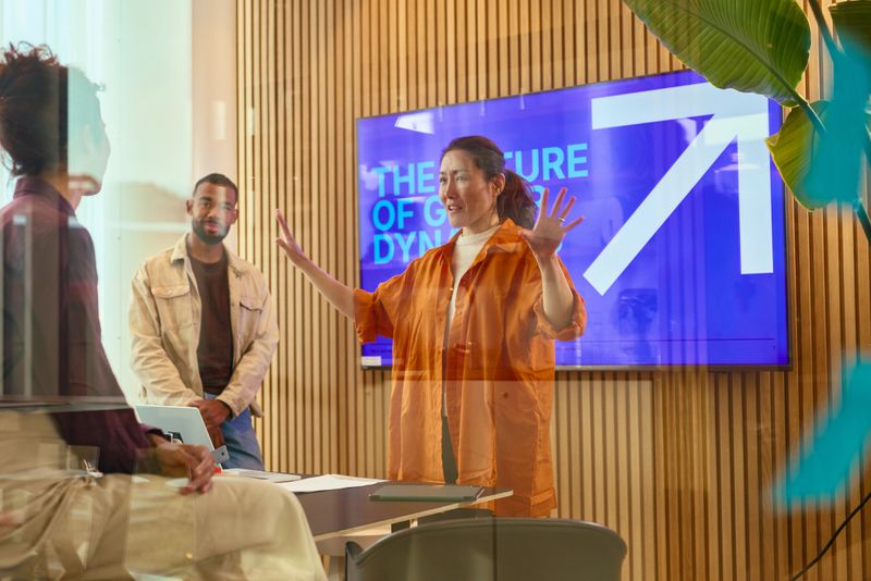 Diverse team of professionals engaging in a discussion about the future of group dynamics in a contemporary office setting