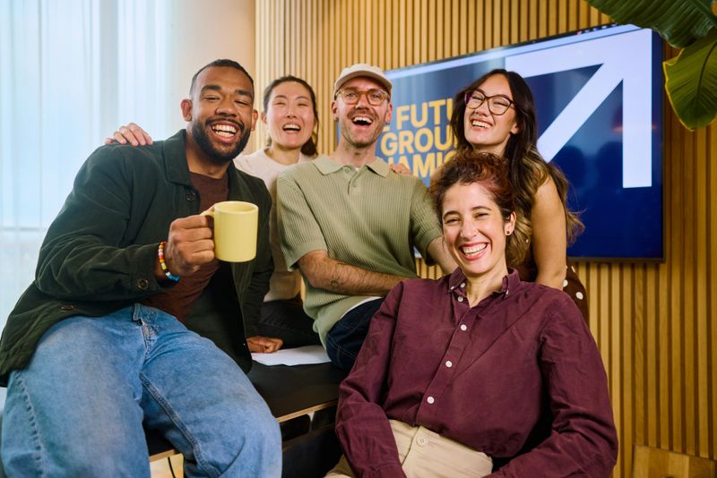 Group of happy entrepreneurs enjoying their workplace, smiling and collaborating in a modern office