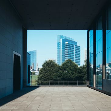 View of modern buildings framed by an urban corridor.