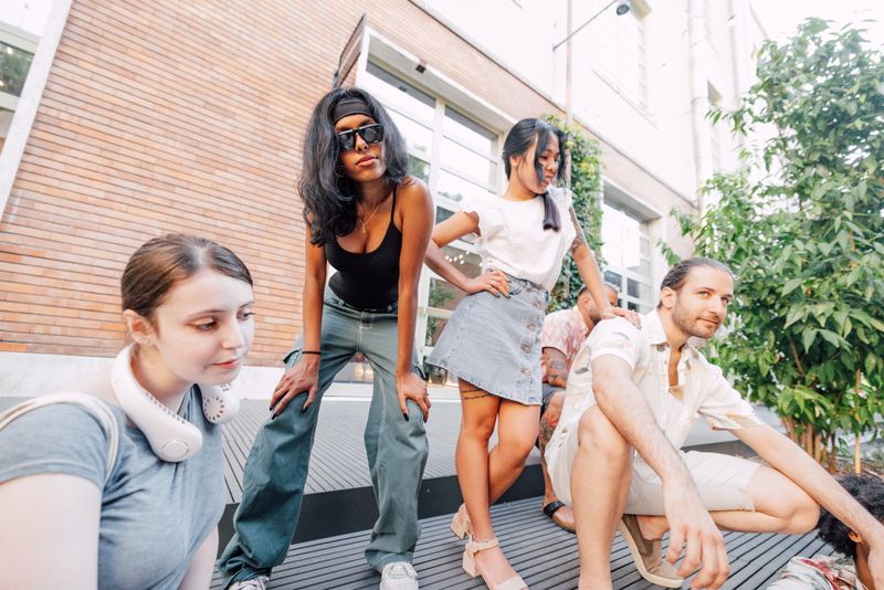 Group of young adults strolling casually on a warm afternoon, capturing the joy of friendship and shared moments.