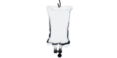 Transparent IV fluid bag hanging from a black metal pole.