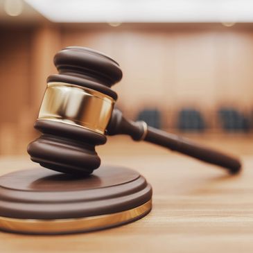 Judge's gavel on desk in courtroom.