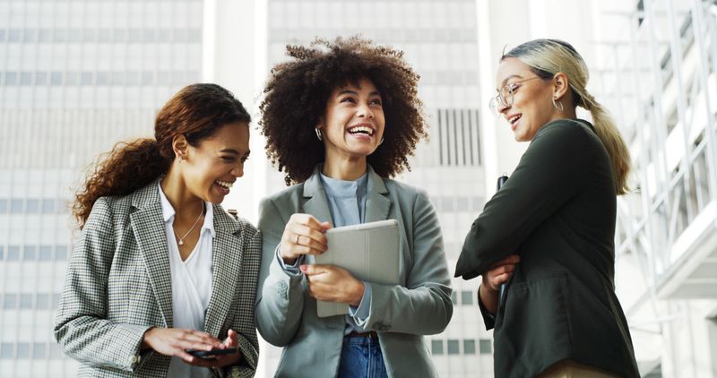Meeting, happy and business women in city for planning, project management and collaboration. Professional, corporate and people with tablet for company discussion, conversation and talking in town