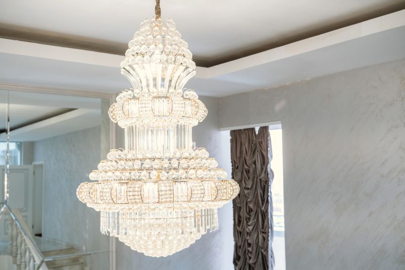 A beautifully crafted chandelier enhances the bright interior decor of a home.