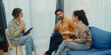A couple discusses their anxiety issues during therapy with a counselor.
