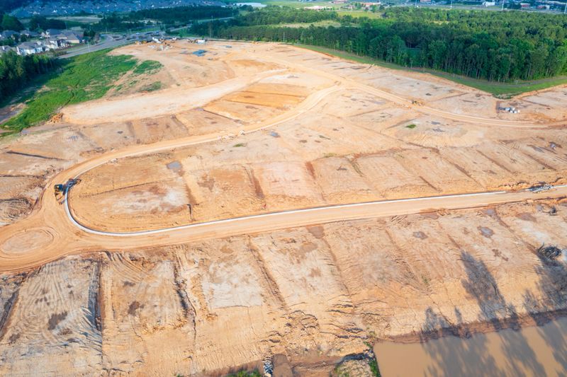 Graded dirt lots ready for new house and neighborhood construction