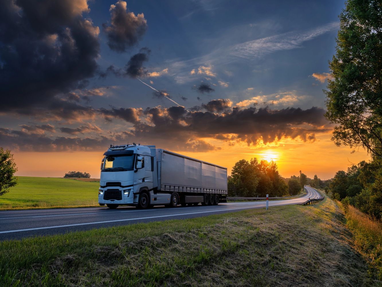 Semi truck on the highway at sunset