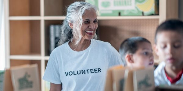 Smiling volunteer woman helping at a community service event.