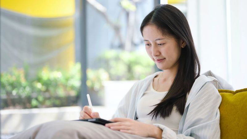 a professional reviewing market data across laptop and smartphone, illustrating ai-driven financial monitoring, real-time stock analysis, and multi-platform investment strategy. relevant for fintech tools, business intelligence, and digital asset management.