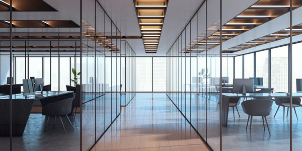 Modern office space with glass partitions and sleek furniture.