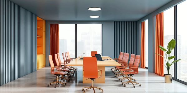 Modern office conference room with orange chairs and curtains.