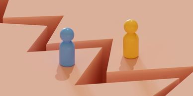 Two colored figures separated by a jagged gap symbolizing division.