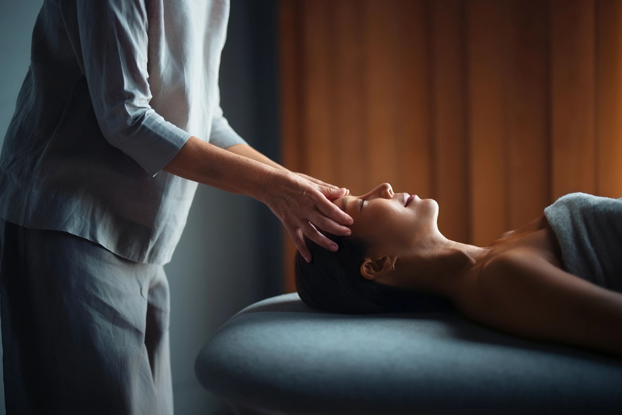 At home massage, person is relaxed and lying down receiving a head massage.