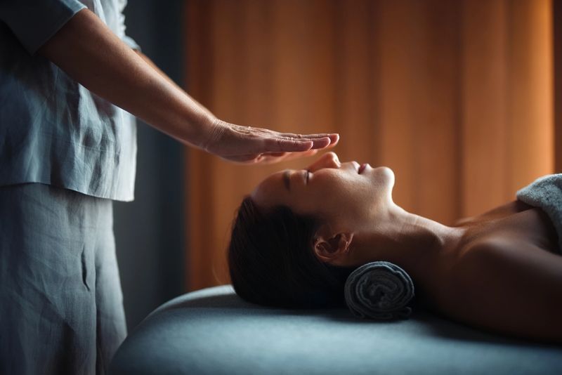 A serene moment during an energy healing session, focusing on tranquility and holistic wellness, performed by a professional in a warm and peaceful atmosphere.