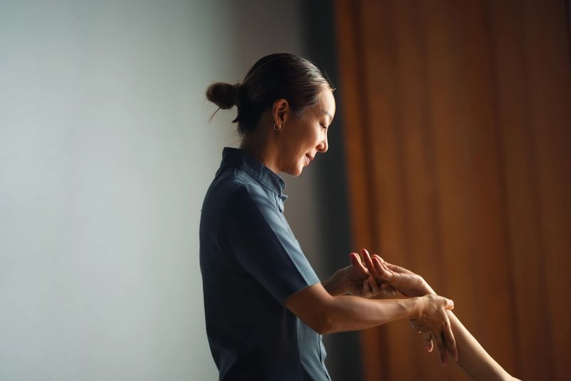 Experienced physical therapist providing dedicated care and guidance during a consultation session in a calm and serene location. The atmosphere fosters relaxation and focus while maintaining a professional demeanor.